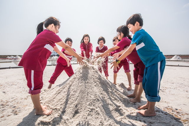 Children play with salt in Salt Fields
